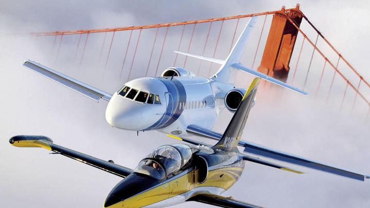 An Aero L-39 Albatros (foreground) and Dassault Falcon 2000 over the Golden Gate Bridge