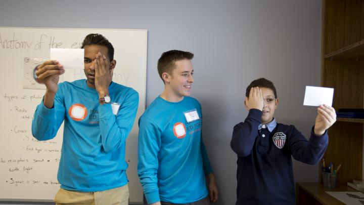 In one of the Ed Portal’s new mentoring spaces, Christ White ’15 (center) teaches fellow undergraduate Tyreke White ’15 and 12-year-old Allston resident Mehdi Kayi about optical illusions.