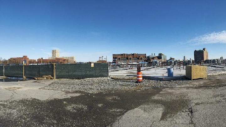 An enterprise research campus (see photo position C on map) is planned for a 36-acre parcel formerly occupied by CSX. In the panoramic view above, Harvard Business School is on the left, Genzyme and the DoubleTree hotel are in the center, and the former WGBH building is on the right. (<a href="http://harvardmagazine.com/sites/default/files/img/article/0215/img_MA15_p27_01.jpg">Click to view a larger image.</a>)