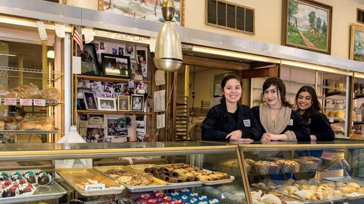 Alejandra Ramirez, Olivia Hitchens, and Gabriela Ramirez (from left to right) preside over the goods at Antoine’s Pastry Shop in Newton.