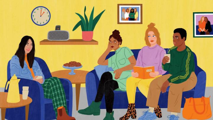 Four young women of different ethnic backgrounds converse in a homey lounge 
