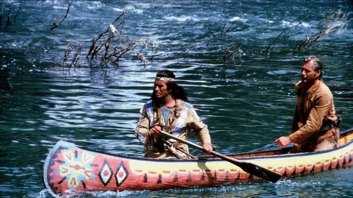 Movie still showing Winnetou and Old Shatterhand paddling a canoe