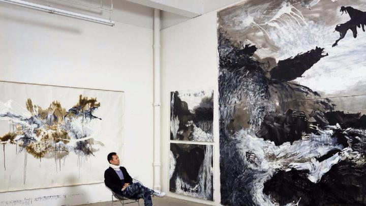 Artist Shen Wei in his studio amid his large-scale abstract paintings 