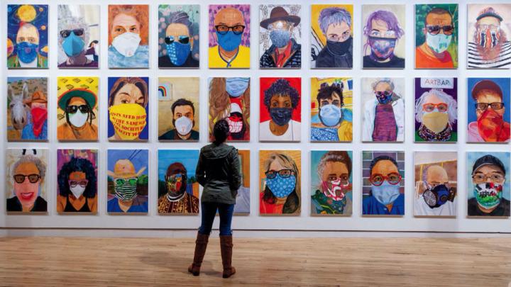 Zoom-like grid of colorful portraits of people in pandemic-era face masks.