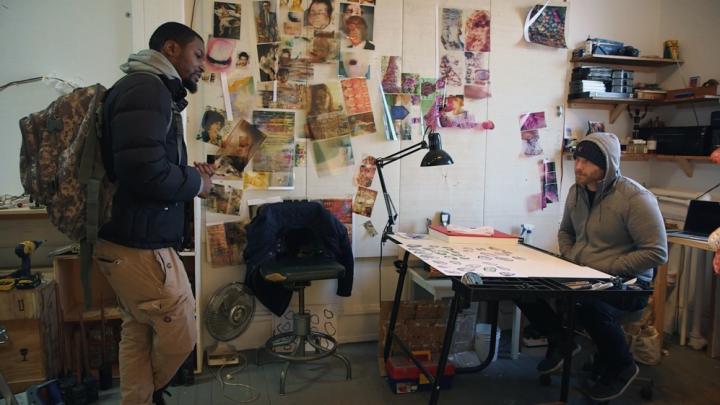 Craig and Krimes talk in an art studio