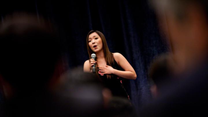 Wenqian (“Wendy”) Wang ’10, who interned in Beijing last summer, closes the March 18 banquet with a rousing version of <i>“Wo ai ni Zhongguo”</i> (“I Love You, China”).