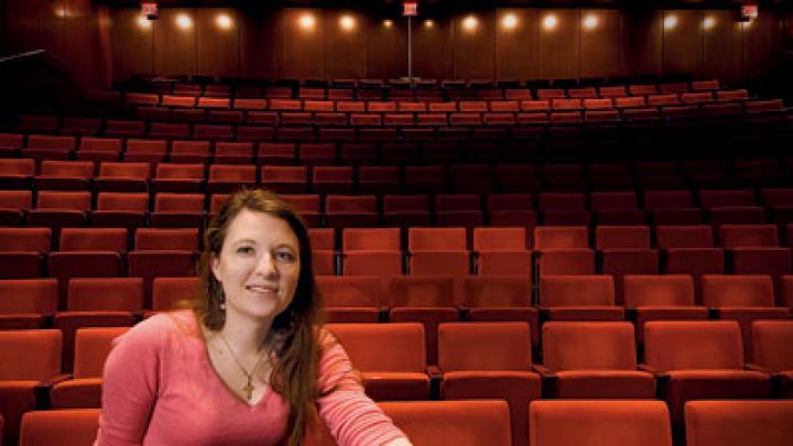 Mary Ellen Stebbins sits under the lights in the New College Theatre.