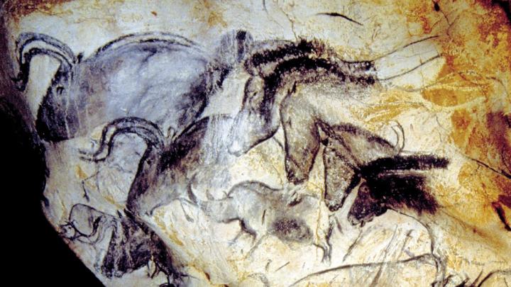 The human urge to create art appears magnificently in the Paleolithic paintings from roughly 30,000 years ago at Chauvet Cave, in southern France. Here, the Panel of the Horses.