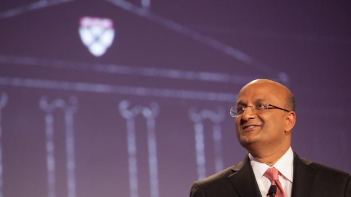 HBS dean Nitin Nohria during his campaign address April 25; a sketch of the iconic Baker Library, with the HBS crest, is projected behind him. 