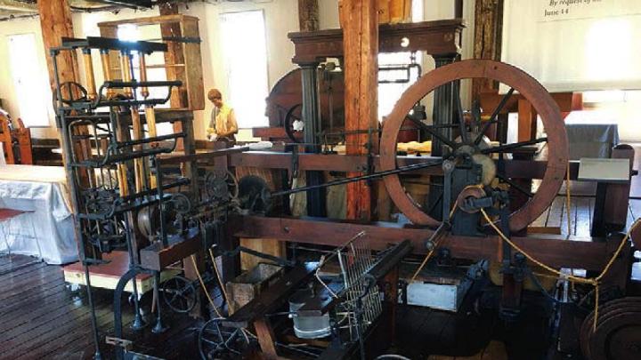 View of early mill machinery constructed of wood and metal 