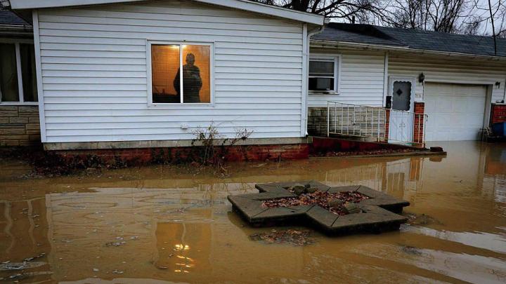 Centreville resident Earlie Fuse looks out his home window at the flooding that his filled his yard.