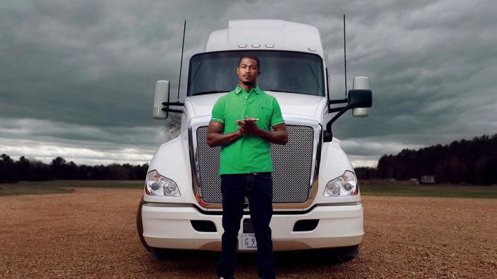 Photograph of Gary Jones standing in front of a tractor trailer truck