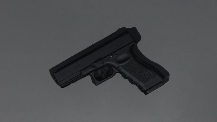 black semi automatic pistol on gray surface