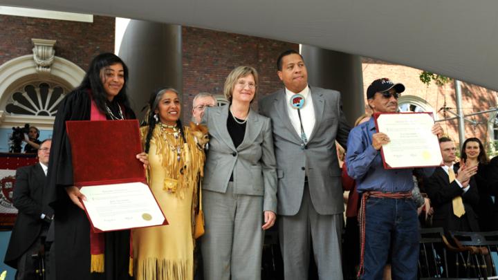 From left: Tiffany Smalley ’11; Cheryl Andrews-Mahats, Aquinnah Tribal Council Chair; Drew Faust; Cedric Cromwell, Mashpee Tribal Council Chair; and Bernard Coombs of the Mashpee Tribe receiving a posthumous diploma for Joel Iacoomes, who would have graduated in 1665.