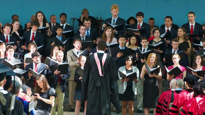 The Commencement Choir, standing on the Memorial Church steps in front of the Commencement platform, sings the premiere of the musical setting of Seamus Heaney's "Villanelle for an Anniversary."