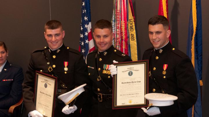 Newly commissioned U.S. Marine officers Brian Furey and Gavin Pascarella (left and right) after taking the oath of office, which was administered by Captain Bryan Warner