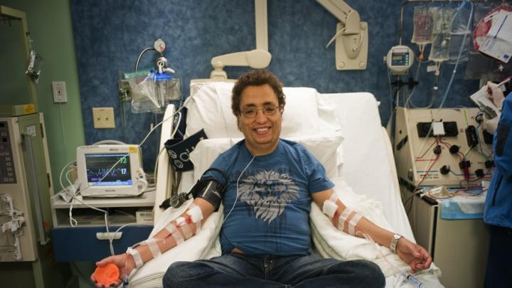 All in a day’s treatment: Khaled, seen in these photographs with hemapheresis practitioner Beverly Gedutis, R.N., and author David Nathan, spent May 8 at Children’s Hospital Boston, where for decades he has been transfused with red blood cells every three weeks. The bottles he carries below contain the iron chelator deferisirox.
