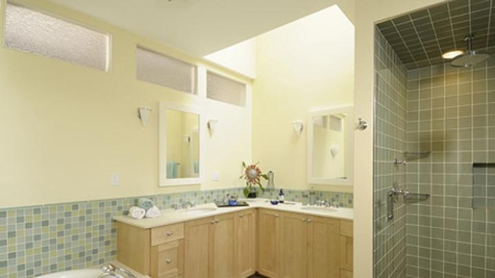 Another use of transom windows to bring light to a bathroom lacking exterior windows