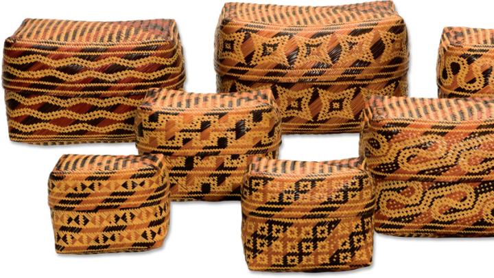 Her baskets display the patterns “Worm Tracks” (rear, left and right), “Grape Skins” (rear, center), and (foreground, from left) “Bottom of Basket,” “Up Across and Down,” “Something Around,” and “Alligator Guts.”