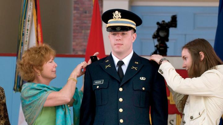 New second lieutenant Christopher Higgins ’11 has his bars pinned on by his mother and sister.
