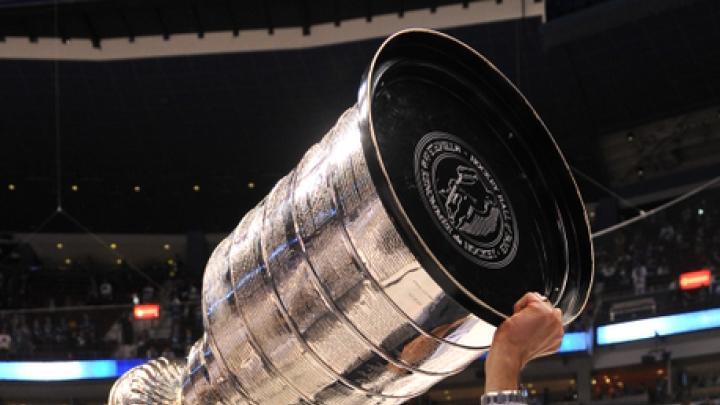 The Bruins' Don Sweeney '88 hoists the Stanley Cup.