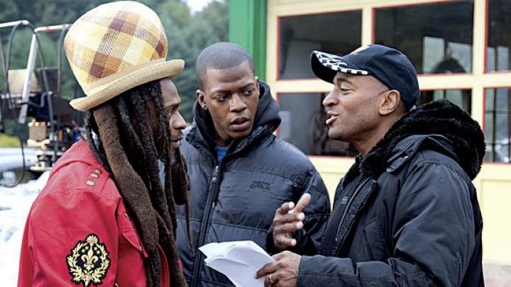 Khan advising Rastafarian musician David Hinds and Sanders 