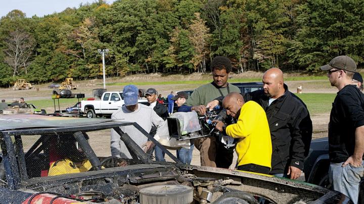 Khan shooting a stock car