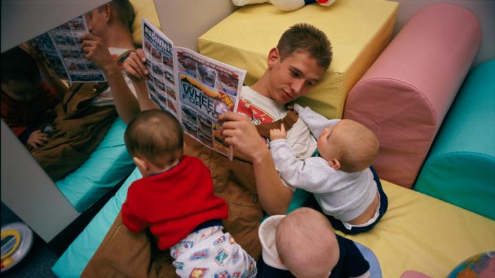 This teenager regularly hurries from  his job to a local day-care center to  spend time with his son in his new role  as a father.