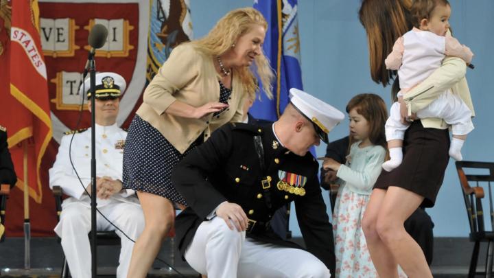 Second Lieutenant Taylor Evans &rsquo;14, already a veteran of five years in the Marine Corps, has his officer&rsquo;s insignia pinned on by his family.