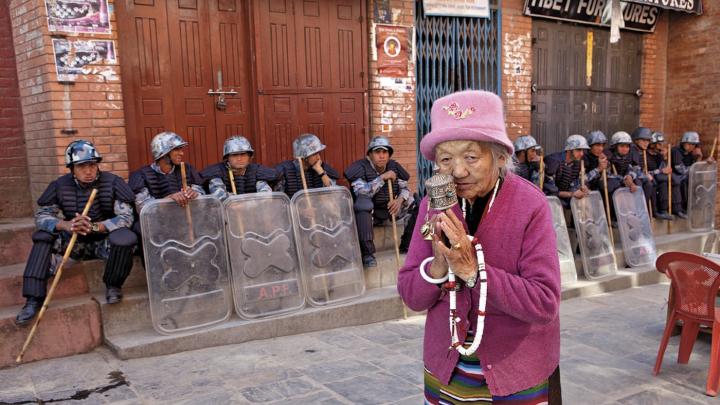 A Tibetan woman praying at the Boudhanath Stupa, near Kathmandu