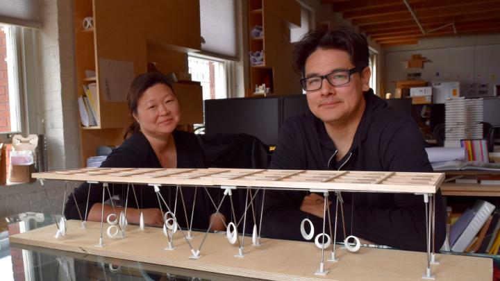 Eric Höweler and Meejin Yoon, with a model of the swings they designed
