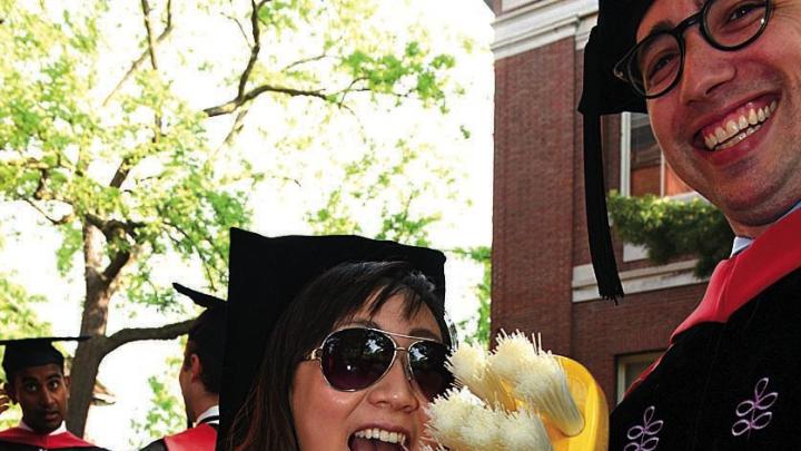 New doctor of medical sciences in oral biology (D.M.Sc.) degree-recipients Mindy Gil, D.M.D. &rsquo;11, of Palos Verdes, California, and Peter Charles Grieco, of Garfield, New Jersey, reminding revelers about good dental hygiene