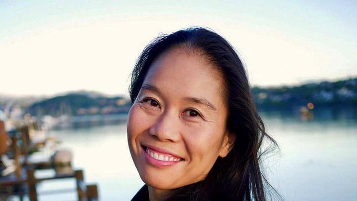 Photo of Bonnie Tsui standing on a pier