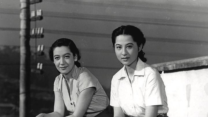 Two women seated looking into the film camera, from Japanese film Tokyo Story