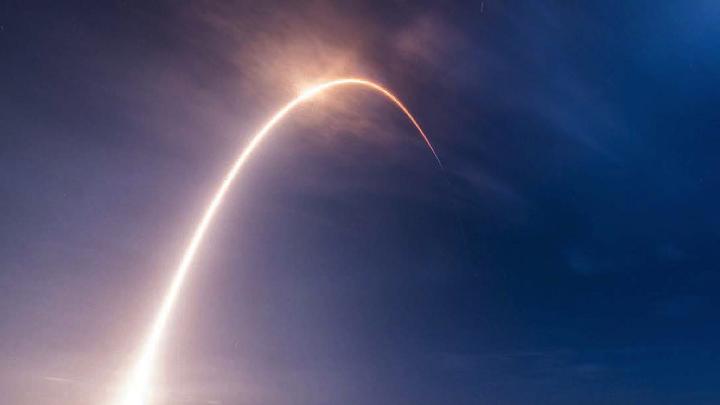 A time-lapse exposure of the SpaceX rocket carrying TEMPO into orbit reveals an arc of light against the sky.