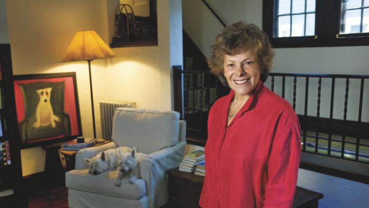 Ellen Langer at home, with her dogs and her own painting of a dog.