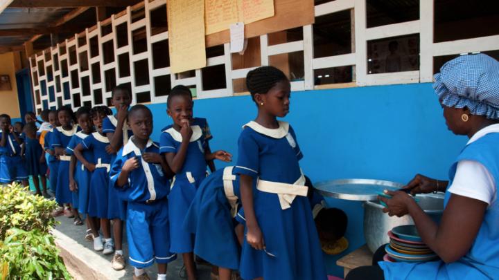 Students at Samrit Academy are served their lunch of kenkey, a popular dish of fermented maize dumplings usually served with soup or stew, in the mid-afternoon. The school caterers receive training through Opportunity International to provide more nutritious and sanitary meals.