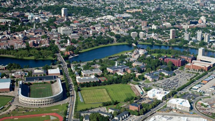 The Harvard campus, looking northeast toward Cambridge from the intersection of Western Avenue and North Harvard Street in Allston, where the mothballed science center dominates the right foreground. William James Hall looms in the distance.  [<a href="http://harvardmagazine.com/sites/default/files/375_so11_003_web_0.jpg">VIEW LARGER PHOTOGRAPH</a>]