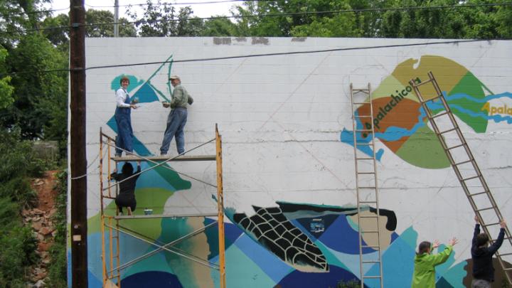 Community volunteers painting <i>Native Waters</i> in Atlanta, Georgia.