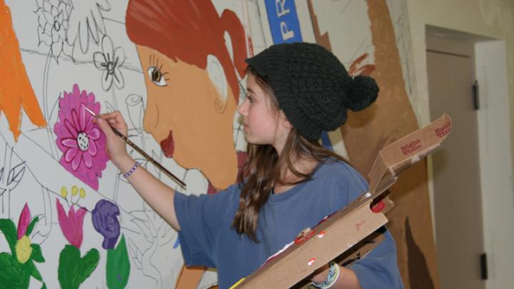 Student working on <i>Lawrence School Garden Mural</i>
