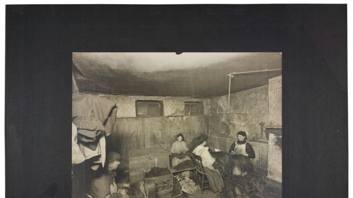 Lewis Wickes Hine, <i>Industrial Problems, Conditions: United States. Pennsylvania. Pittsburgh. Pittsburgh Survey: These Four Strippers Work in a Damp, Unventilated Cellar,</i> 1907–8. Gelatin silver print mounted to board, white gouache.