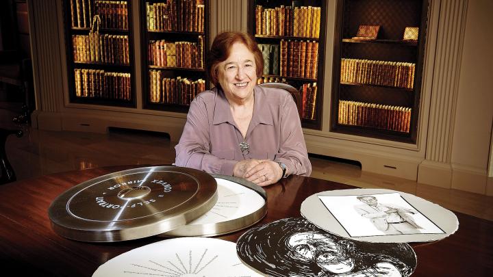 Porter University Professor Helen Vendler in Houghton Library with a copy of the Arion Press edition of John Ashbery's "Self-Portrait in a Convex Mirror"