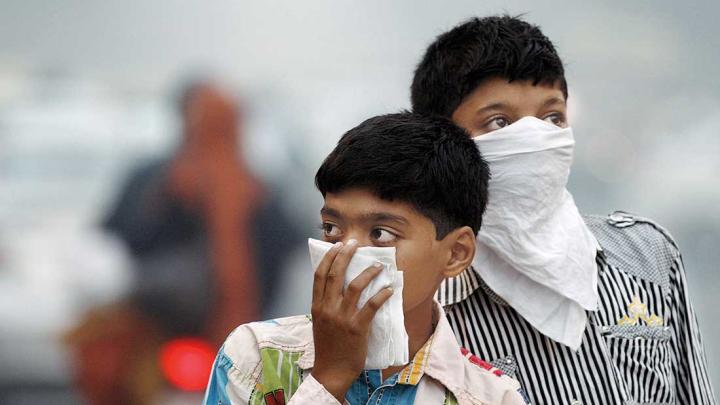 Children protecting themselves from smog and pollution, New Delhi, 2012