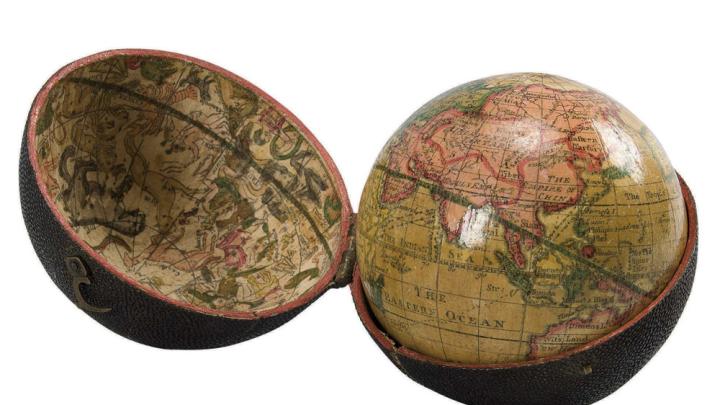 A photograph of an eighteenth-century, three-inch pocket globe in its open case