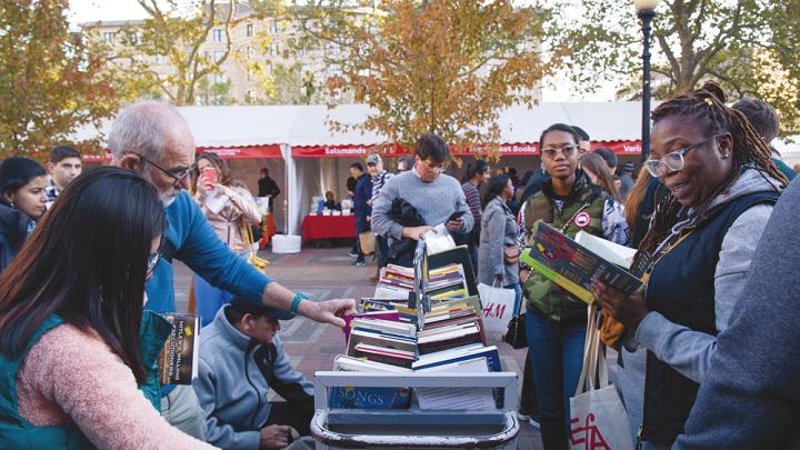 People perusing books outside at the Boston Book Festival 
