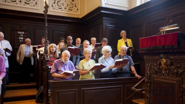 President Faust (standing at upper right, during the singing of Hymn 27) spoke at the first Morning Prayers of the new academic year.