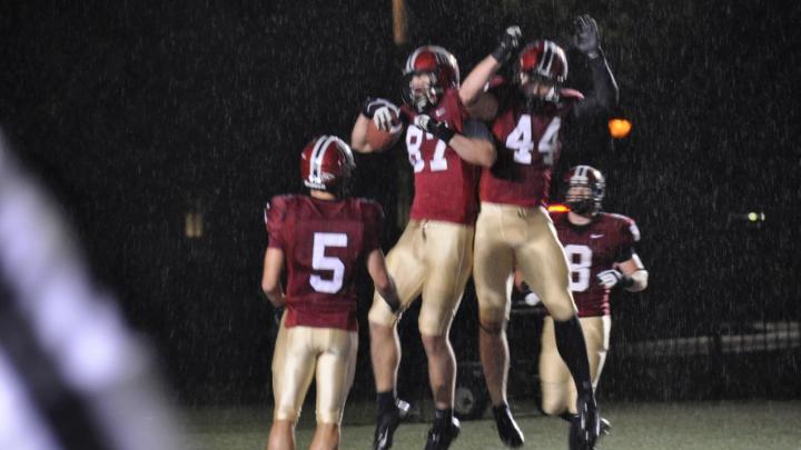 Levitation on a rainy night: Harvard receivers celebrated after a 35-yard touchdown pass to tight end Cameron Brate (87) in the opening period of the Crimson’s 52-3 rout of Holy Cross. Quarterback Colton Chapple threw two scoring passes to Brate and one each to Ricky Zorn (5) and Kyle Juszczyk (44) in a 49-point first half.