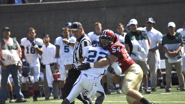 A not-quite-irresistible force meets an immovable object: Crimson linebacker Brian Reilly stopping San Diego tailback Kenn James in Saturday's Stadium opener. The visitors'  running backs netted just 35 yards rushing against a staunch Harvard defense.