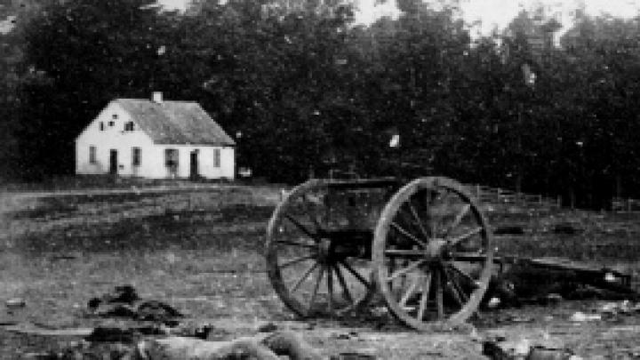 Dead Confederate artillerymen grouped near one of their limbers after Antietam. In the background is a Dunker church, built by a German Baptist pacifist sect.