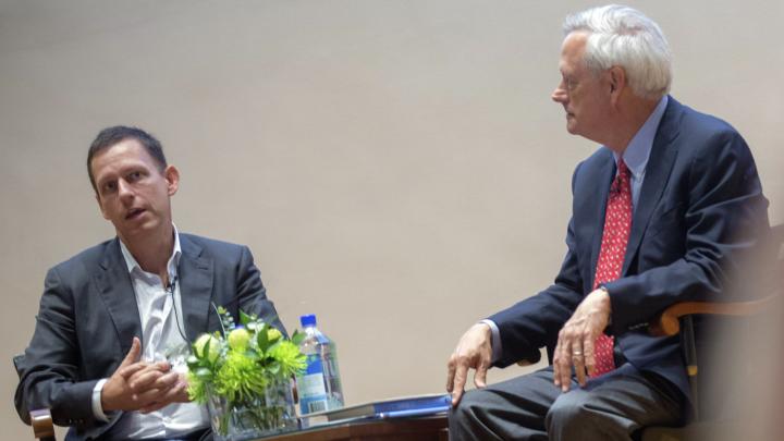 Entrepreneur Peter Thiel (left) and professor of business administration William A. Sahlman discuss the power of monopolies at an event in Burden Hall.